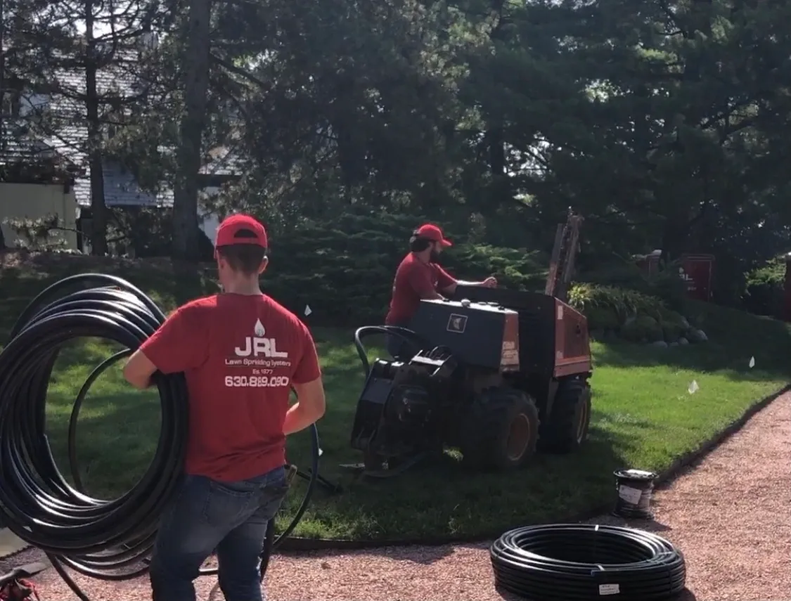 A group of people working on the grass.